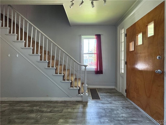 entryway featuring dark hardwood / wood-style floors and crown molding