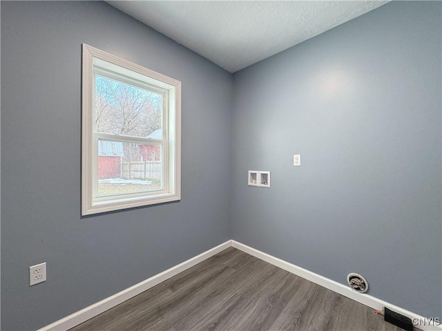 laundry room with washer hookup, a textured ceiling, and hardwood / wood-style floors