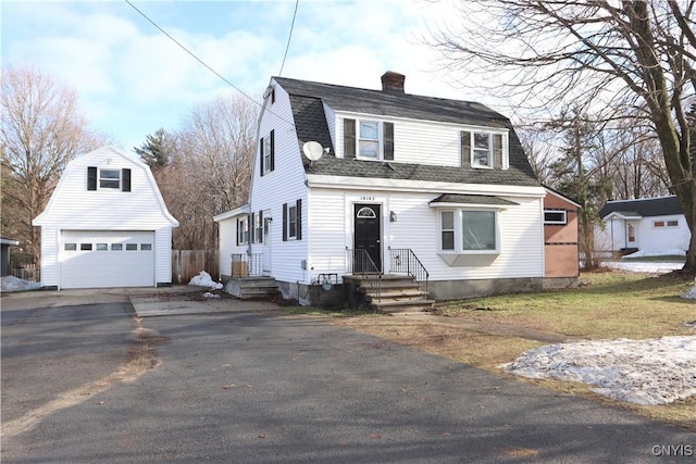 front of property with a garage and an outdoor structure