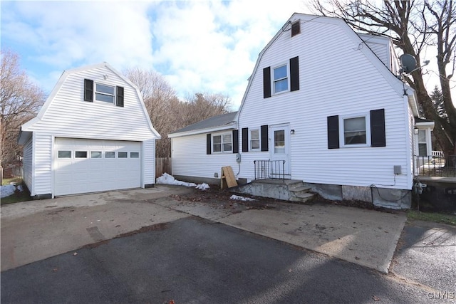 view of front facade featuring a garage and an outbuilding