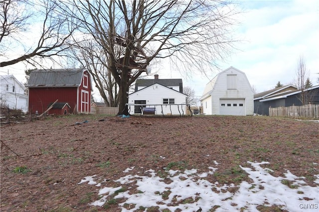 snowy yard featuring an outbuilding