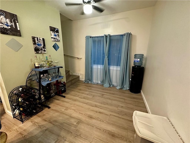 sitting room with light hardwood / wood-style floors and ceiling fan