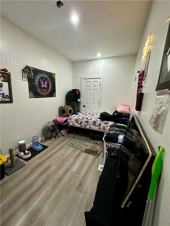 bedroom with hardwood / wood-style floors