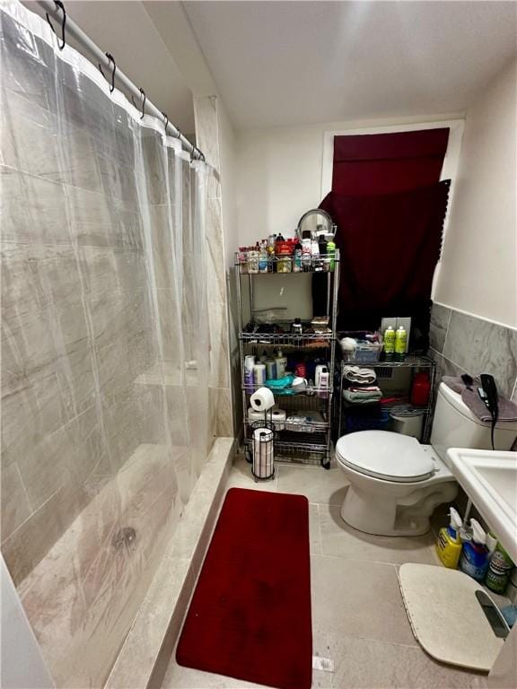 bathroom with tile patterned floors, toilet, and walk in shower