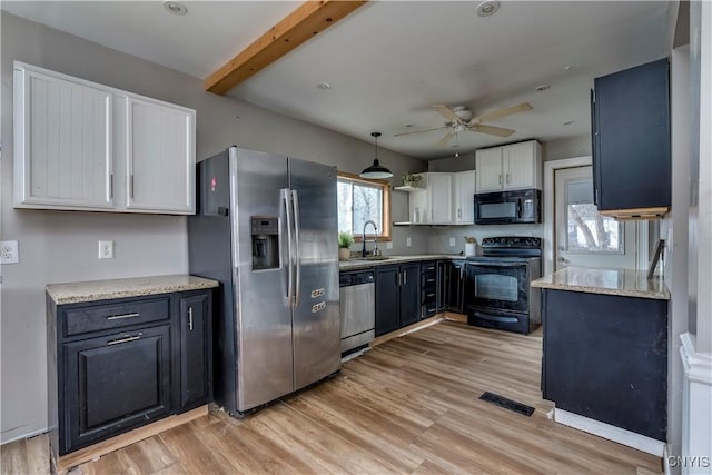 kitchen with ceiling fan, black appliances, beamed ceiling, white cabinets, and light hardwood / wood-style floors