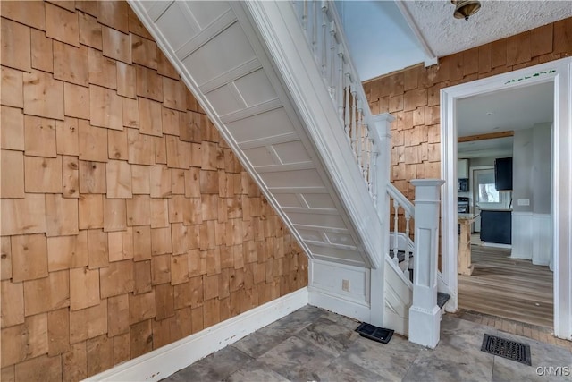 staircase featuring lofted ceiling