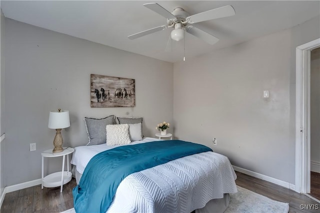 bedroom featuring ceiling fan and dark hardwood / wood-style floors