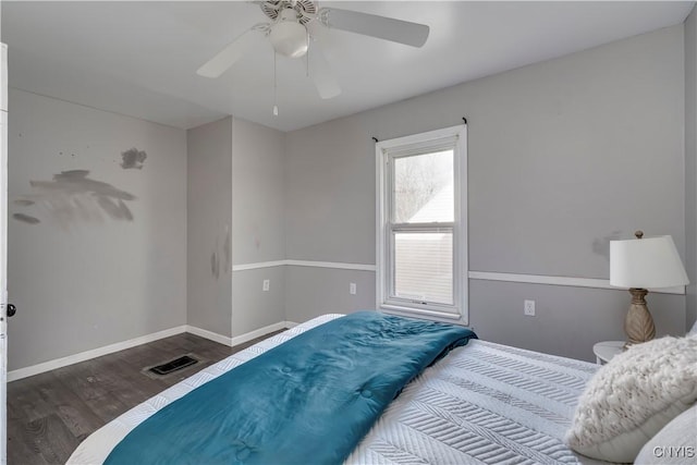 bedroom with ceiling fan and dark hardwood / wood-style flooring