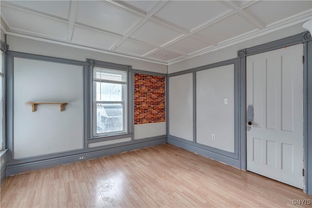 spare room featuring coffered ceiling and light wood-type flooring