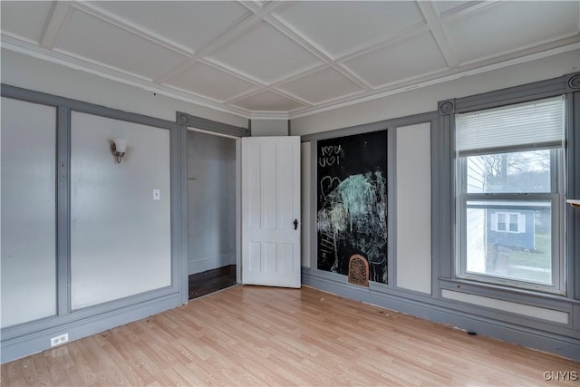 unfurnished room with hardwood / wood-style floors, a wealth of natural light, and coffered ceiling