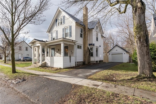 view of front of property featuring a garage and an outdoor structure