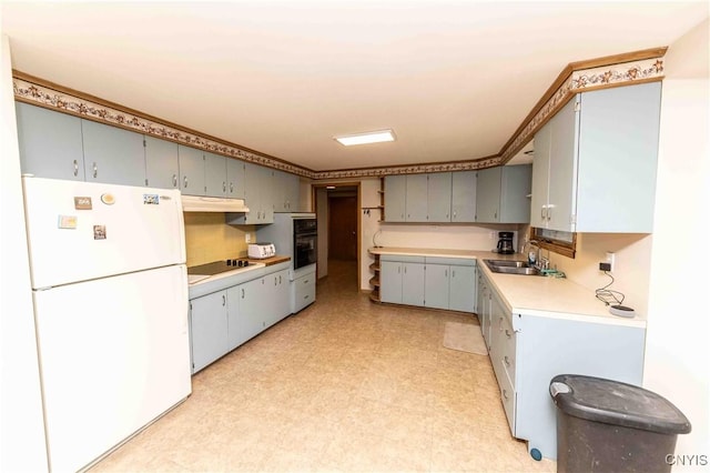 kitchen featuring gray cabinetry, sink, and white appliances