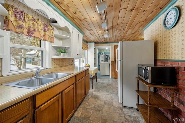 kitchen featuring sink, wood ceiling, track lighting, and white refrigerator