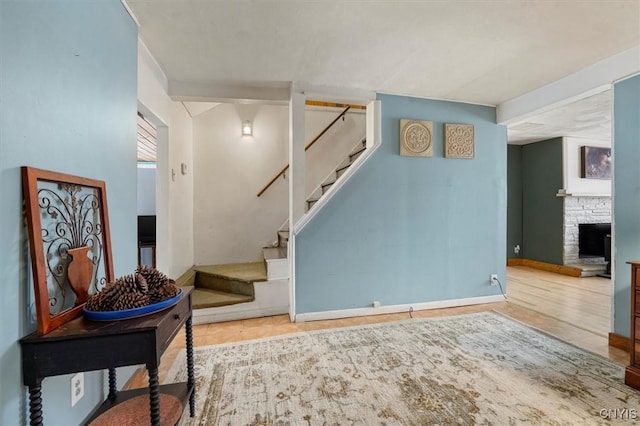 staircase with a fireplace and tile patterned floors