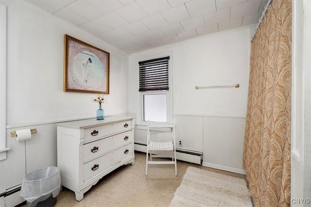 living area with ornamental molding and a baseboard radiator