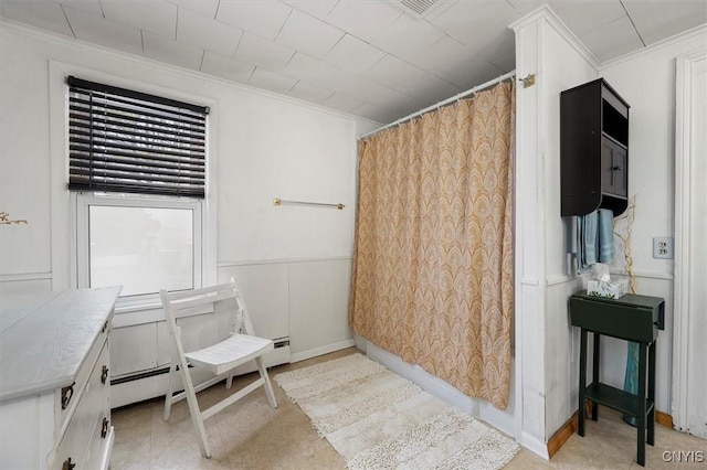 bathroom featuring ornamental molding and a baseboard radiator