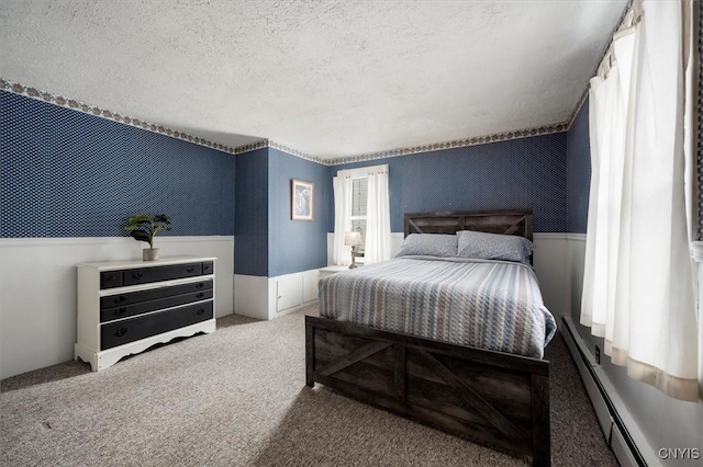 carpeted bedroom with a textured ceiling and a baseboard radiator