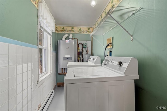 laundry area with separate washer and dryer, tile walls, and water heater