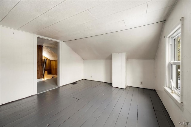 bonus room with dark hardwood / wood-style floors and lofted ceiling