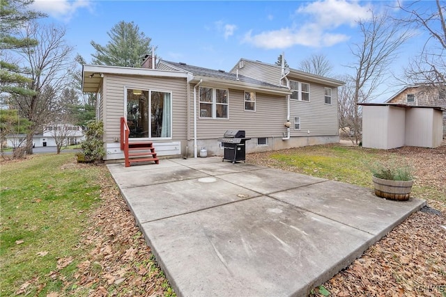 back of house featuring a patio area, a yard, and a shed