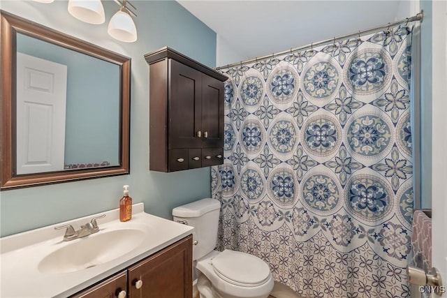 bathroom featuring vanity, curtained shower, and toilet