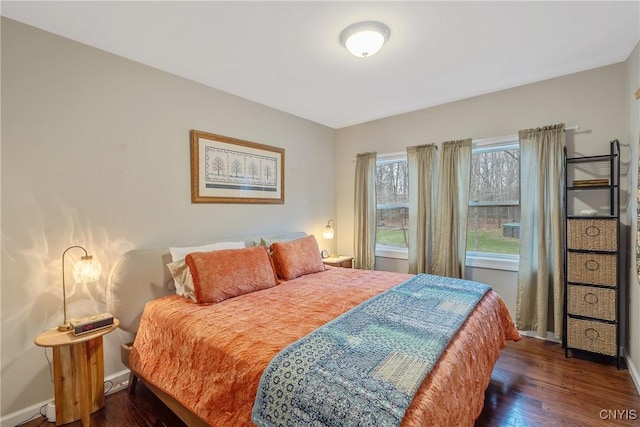 bedroom with dark hardwood / wood-style floors