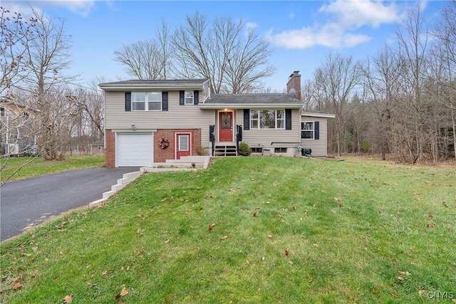 tri-level home featuring a garage and a front lawn