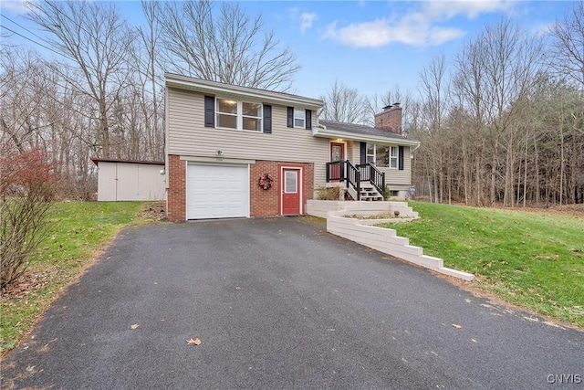 tri-level home with a front yard and a garage