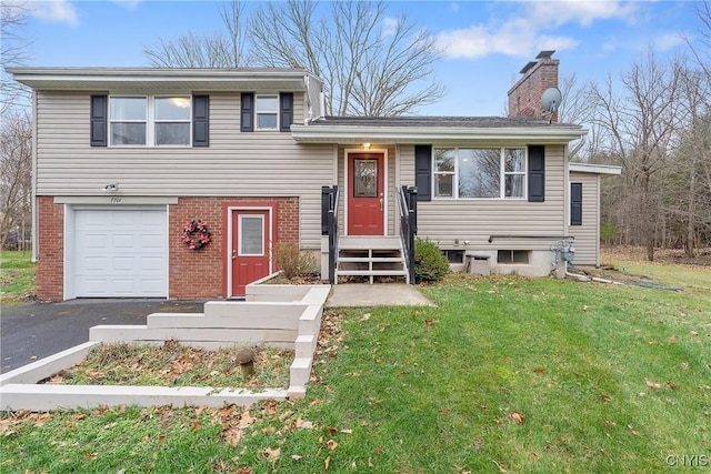 tri-level home featuring a garage and a front lawn