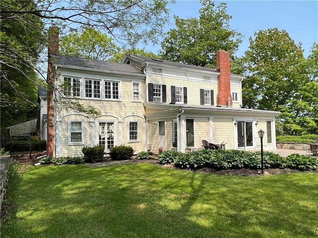 rear view of house featuring a lawn and a patio area