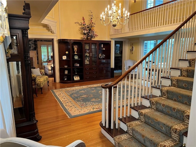 1470 State Route 19, Middlebury, NY 14591 - entrance foyer featuring stairs, a chandelier, wood finished floors, plenty of natural light, and a high ceiling