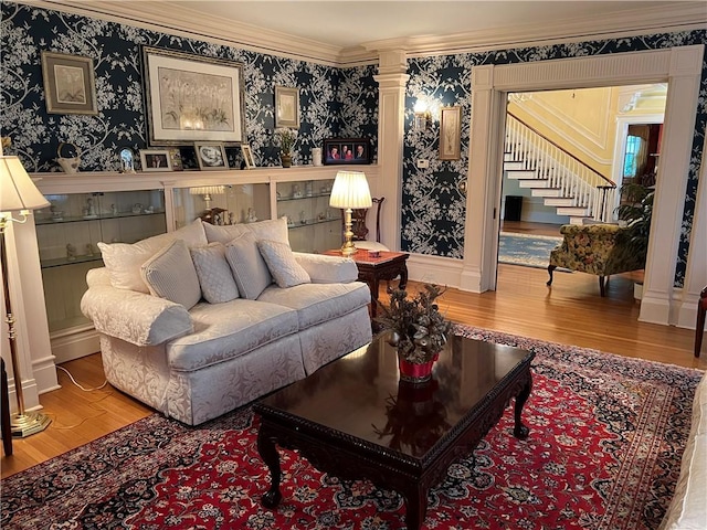 1470 State Route 19, Middlebury, NY 14591 - living room with wood finished floors, ornamental molding, stairs, wallpapered walls, and decorative columns