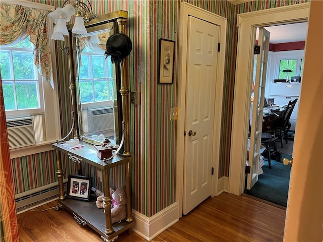 1470 State Route 19, Middlebury, NY 14591 - hall featuring wood finished floors, a baseboard radiator, wallpapered walls, an office area, and cooling unit