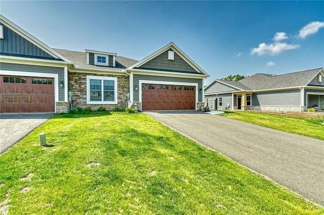 craftsman inspired home with a garage and a front yard