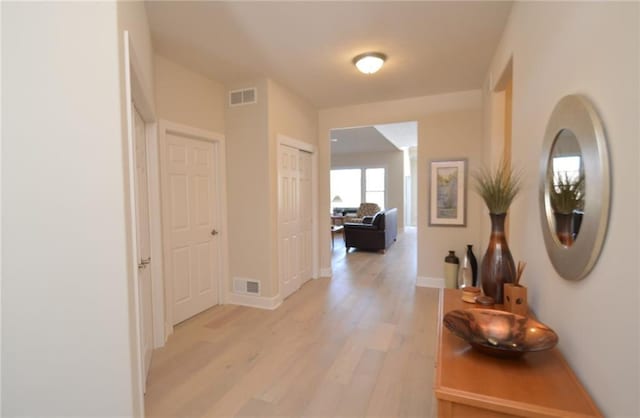 hall with light hardwood / wood-style floors