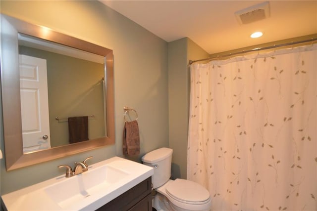 bathroom with a shower with curtain, vanity, and toilet