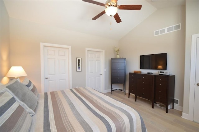 bedroom with ceiling fan, light hardwood / wood-style floors, and lofted ceiling