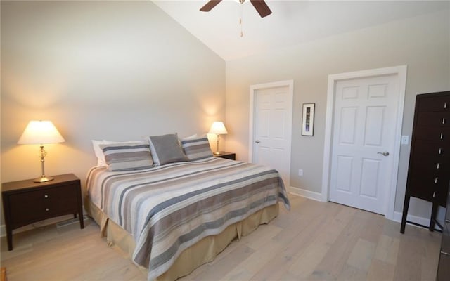 bedroom featuring light wood-type flooring, vaulted ceiling, and ceiling fan