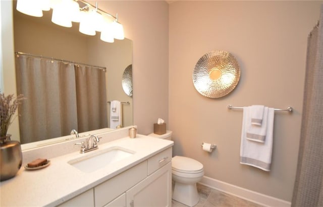 bathroom with tile patterned flooring, vanity, and toilet