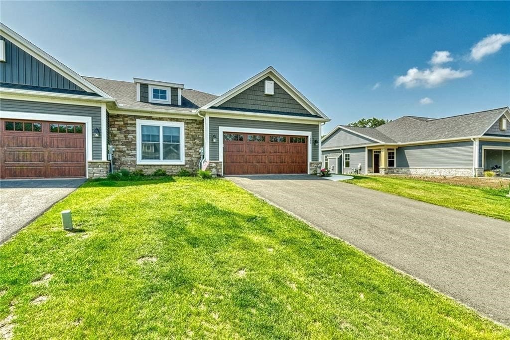 craftsman-style home with a garage and a front yard