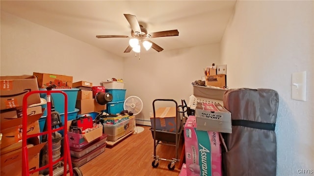 playroom featuring hardwood / wood-style floors, ceiling fan, and a baseboard radiator