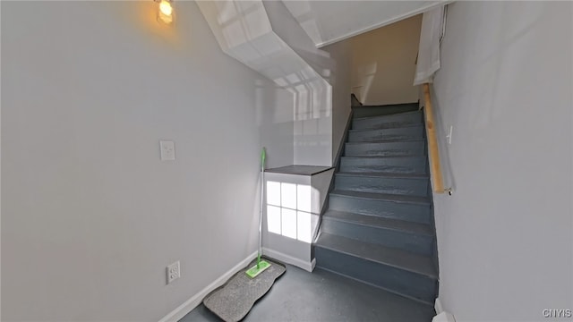 stairs featuring concrete floors