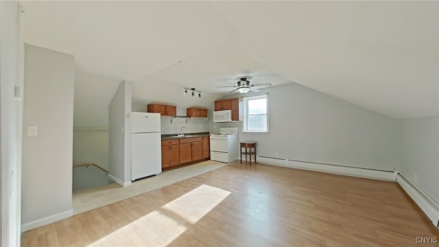 kitchen featuring light wood-type flooring, white appliances, a baseboard radiator, and vaulted ceiling