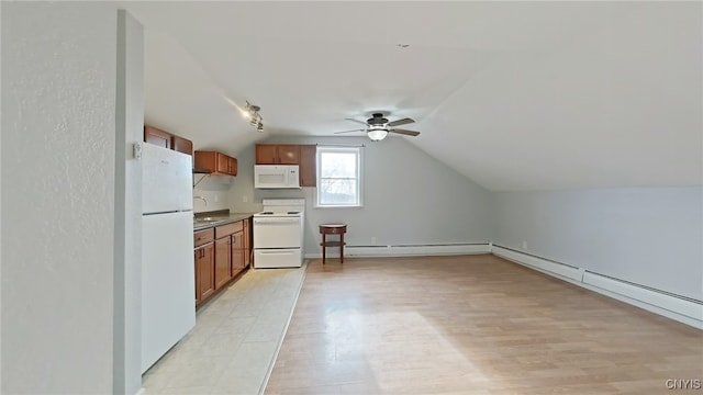 kitchen featuring lofted ceiling, ceiling fan, white appliances, and sink