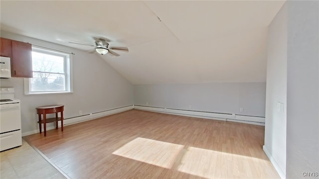 bonus room with light hardwood / wood-style floors, vaulted ceiling, ceiling fan, and a baseboard heating unit