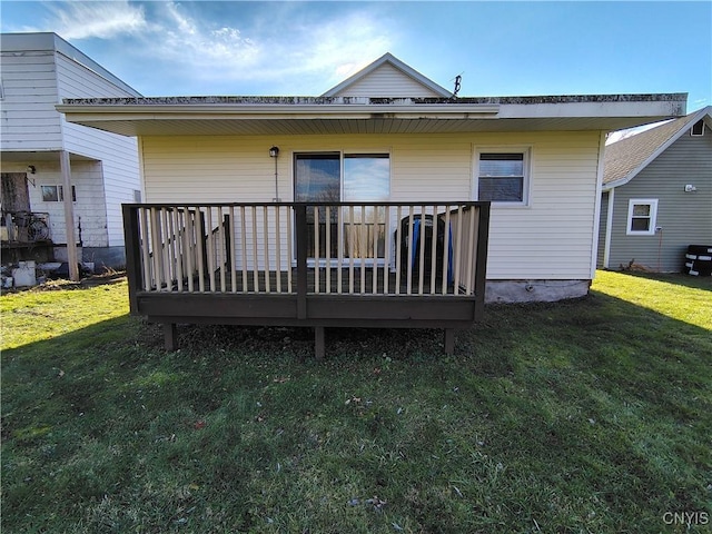 back of house with a wooden deck and a yard