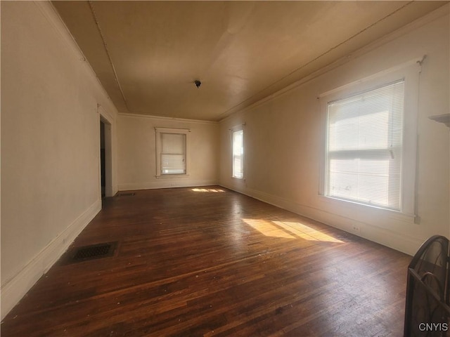 unfurnished room featuring crown molding and dark wood-type flooring