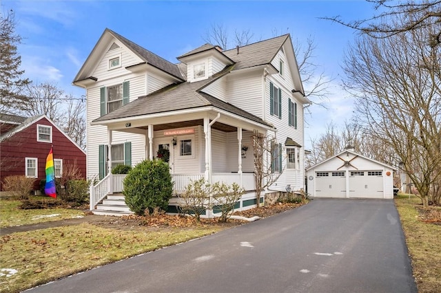 front of property featuring an outbuilding, a garage, and covered porch