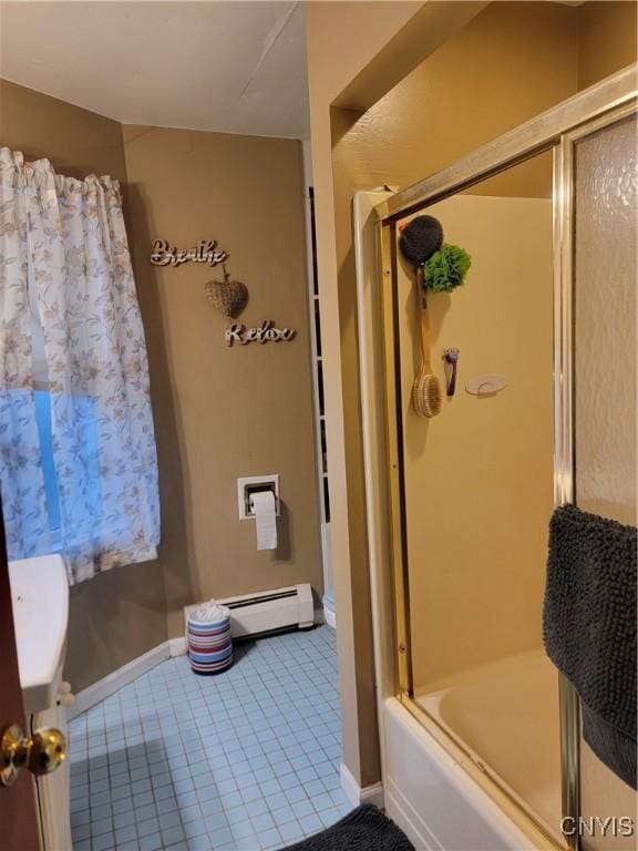 bathroom featuring tile patterned flooring, a baseboard heating unit, and enclosed tub / shower combo