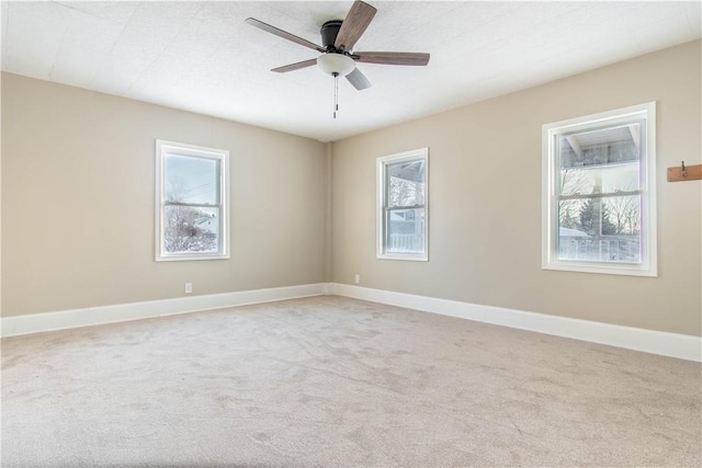 carpeted spare room with ceiling fan